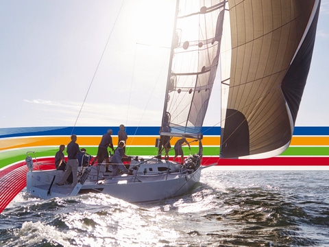 People on a sailing boat in the ocean, under a bright sky, surrounded by a key visual of four lines in blue, orange, green and red (photoshopped) People on a sailing boat in the ocean, under a bright sky, surrounded by a key visual of four lines in blue, orange, green and red (photoshopped)
