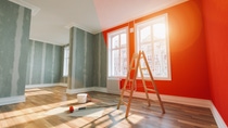 Painting wall red in room before and after restoration or refurbishment