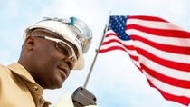 Man in BASF work clothes and US flag 