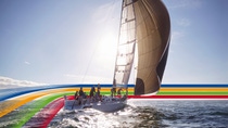 People on a sailing boat in the ocean, under a bright sky, surrounded by a key visual of four lines in blue, orange, green and red (photoshopped)  People on a sailing boat in the ocean, under a bright sky, surrounded by a key visual of four lines in blue, orange, green and red (photoshopped)