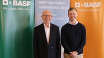 Two people standing in front of BASF banners Two people standing in front of BASF banners