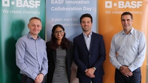 Four people standing in front of 3 BASF banners Four people standing in front of 3 BASF banners