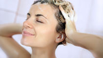 Woman rubbing conditioner in her hair 