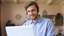 Freelance operator talking with headsets and consulting clients from home office