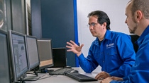 Engine test bed for diesel passenger cars: Technician Agustin Felipe Angeles Navarro (left) and Test Engineer Daniel Schatz (right) monitor the results of the emissions test in front of the computer. Attached to measuring instruments computer programs register all emission values during the test. In the Hannover Engine Lab future catalyst technologies are tested on their functionality and durability under real life conditions.