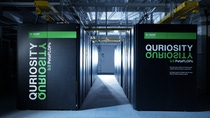 View into the server room of 'Quriosity', BASF's supercomputer at the Ludwigshafen site. Large black server cabinets with the green 'Quriosity' branding line a corridor, illuminated by accent lighting, showcasing BASF's high-performance computing infrastructure for research and development.