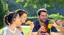 Group of people laughing and having a picnic cheer-sing cups  Group of people laughing and having a picnic cheer-sing cups