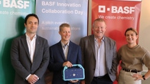 Four people standing in front of BASF banners