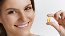 Vitamins. Close Up Of Happy Beautiful Girl With Pill With Cod Liver Oil Omega-3. Nutrition. Healthy Lifestyle. Nutritional Supplements. Sport, Diet Concept. Vitamin D, E, A Fish Oil Capsules.; Shutterstock ID 338420033