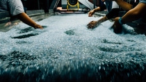 Human hands sliding through plastic granules. Human hands sliding through plastic granules.