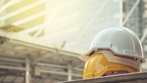 white, yellow hard safety helmet hat for safety project of workman as engineer or worker, on concrete floor on city white, yellow hard safety helmet hat for safety project of workman as engineer or worker, on concrete floor on city