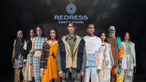 A line-up of models in front of the redress logo.