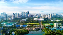 JAKARTA - Indonesia. March 26, 2018: Beautiful landscape of Senayan stadium complex with skyscrapers under blue sky  JAKARTA - Indonesia. March 26, 2018: Beautiful landscape of Senayan stadium complex with skyscrapers under blue sky
