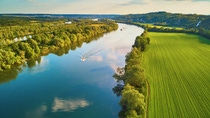 Scenic aerial view of the Seine river and green fields in French countryside. Scenic aerial view of the Seine river and green fields in French countryside.