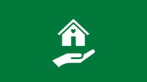 White icon showing a house with a heart above an open hand on a green background, representing family care solutions.