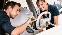 two employees working on automotive  two employees working on automotive