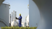 BASF employee standing on green grass outside production site 