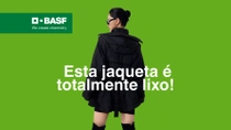 A woman wearing a black jacket against a green background. The text reads: "This jacket is total trash! Discover more in our YouTube video."