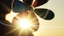 A silhouette image of a child with a rainbow coloured pinwheel, looking at the sunset setting on the horizon, with sketch lines showing the path of the wind over her pinwheel. A silhouette image of a child with a rainbow coloured pinwheel, looking at the sunset setting on the horizon, with sketch lines showing the path of the wind over her pinwheel.