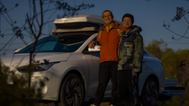 Two man standing in front of a white car. Two man standing in front of a white car.