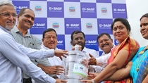 Men and women on Navi stage in Mumbai holding BASF's water jug