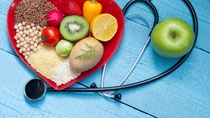 Food on heart plate with stethoscope cardiology concept Food on heart plate with stethoscope cardiology concept