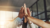 Shot of a group of colleagues giving each other a high five