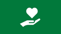 White hand holding a heart icon on a green background, representing care, social responsibility, and giving back.