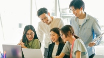 Asian business people are looking at their business plans together on their laptop screens Asian business people are looking at their business plans together on their laptop screens