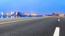 Urban asphalt road and modern buildings with river in Hangzhou at night Urban asphalt road and modern buildings with river in Hangzhou at night
