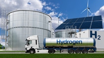 Truck with hydrogen tank trailer on the background of gas storage. New energy sources Truck with hydrogen tank trailer on the background of gas storage. New energy sources