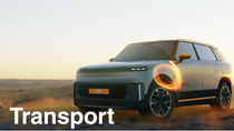 A light-colored SUV stands in a desert landscape at sunset, with a glowing light-ring effect over the front wheel. The text reads: "Transport."