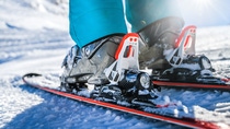 Winter skis and detailed view of the ski bindings concept in sunny day. 