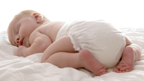 Cute baby in diapers sleeping 