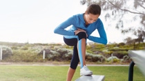 Sporty young woman stretching in the park Sporty young woman stretching in the park