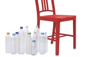 Empty water bottles beside a red chair  Empty water bottles beside a red chair