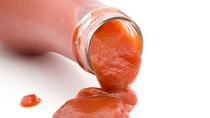 Ketchup pouring out of a bottle 