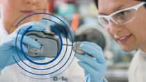 Two BASF scientists examining device  Two BASF scientists examining device