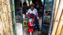 Woman riding moped indoors Woman riding moped indoors