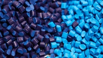 Close up of a two stacks of blue plastic polypropylene granules on a table. Close up of a two stacks of blue plastic polypropylene granules on a table.