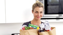 portrait of a young woman holding two brown paper grocery bags portrait of a young woman holding two brown paper grocery bags