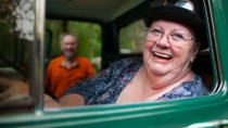 Close up of an elderly woman sitting in a green car. Close up of an elderly woman sitting in a green car.
