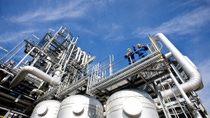view of BASF production site and two men in blue overalls and yellow hard hat from below