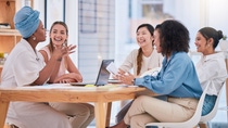Employees engage in an open discussion, reflecting collaboration, inclusion, and a culture of feedback.
