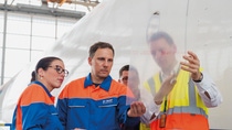 In order to equip a Boeing 777 with the fuel-saving surface technology on a large scale, BASF's cooperation partner Lufthansa Technik uses the aircraft's regular maintenance idle times. After a sophisticated design, the film patches are cut to size and attached exactly along the flow course of the fuselage and the engine nacelles. The application of about 2,000 patches is carried out in sections over several days by a trained team. In order to equip a Boeing 777 with the fuel-saving surface technology on a large scale, BASF's cooperation partner Lufthansa Technik uses the aircraft's regular maintenance idle times. After a sophisticated design, the film patches are cut to size and attached exactly along the flow course of the fuselage and the engine nacelles. The application of about 2,000 patches is carried out in sections over several days by a trained team.