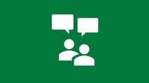 White icon showing two people with speech bubbles on a green background, representing coaching, mentoring, and knowledge exchange.