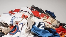 Pile of used sports jerseys   Pile of used sports jerseys