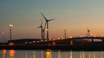 Landscape view of a bridge by the water with windmills during sunset  Landscape view of a bridge by the water with windmills during sunset