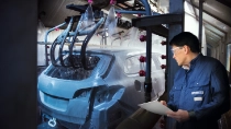 Car bodies being cleaned prior to spraying in car factory Car bodies being cleaned prior to spraying in car factory