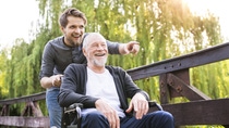 Hipster son walking with disabled father in wheelchair at park.; Shutterstock ID 655349716; Jobnummer: 20728885; Projekt: Pros LuMit; Endkunde: BASF SE; Sonstiges: BASF SE, ESI/K, Frau Peichl